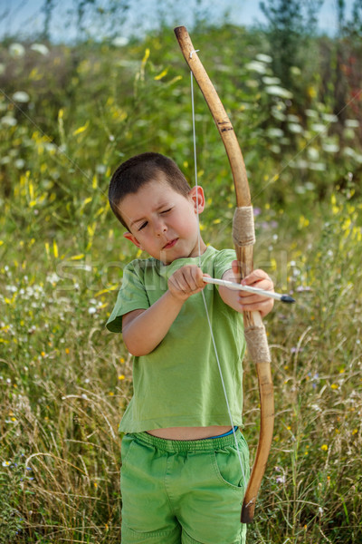 Stock photo: Boy shoots a bow