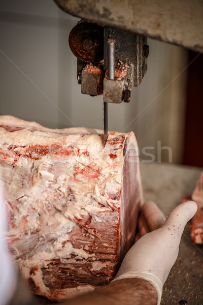 Butcher is cutting beef meat Stock photo © grafvision