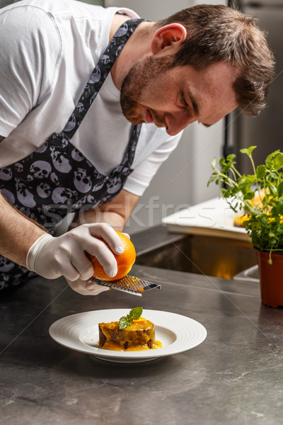 Chef rasping orange zest Stock photo © grafvision