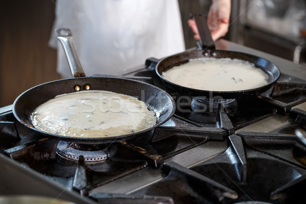 Stock photo: Pancakes cooking in a griddle