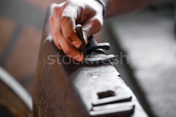 Blacksmith forges a horseshoe. Stock photo © grafvision