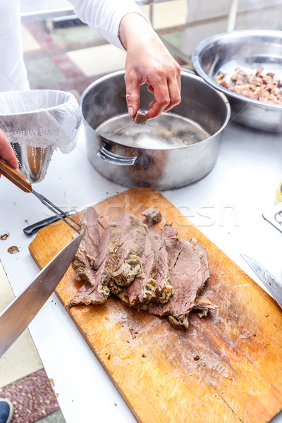 The cook cuts boiled beef meat Stock photo © grafvision