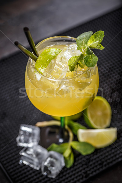 Cocktail garnished with a lime slice and mint leaf Stock photo © grafvision