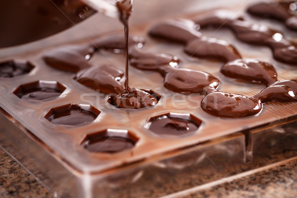 Putting chocolate in mold Stock photo © grafvision