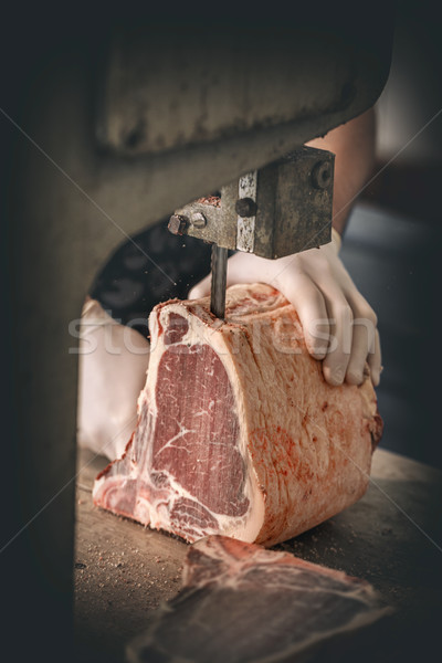 Butcher is cutting beef meat Stock photo © grafvision