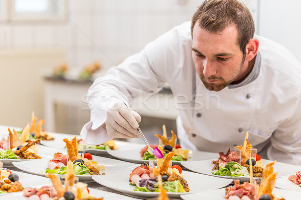 Chef garnishing his appetizer plate Stock photo © grafvision