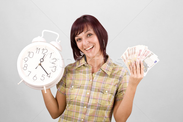 Woman holding clock and money Stock photo © grafvision
