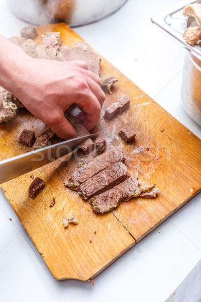 The cook cuts boiled beef meat Stock photo © grafvision