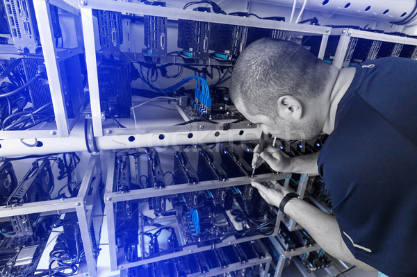 Programmer adjusting cryptocurrency mining rig Stock photo © grafvision