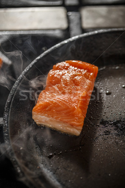 Frying salmon in black pan Stock photo © grafvision