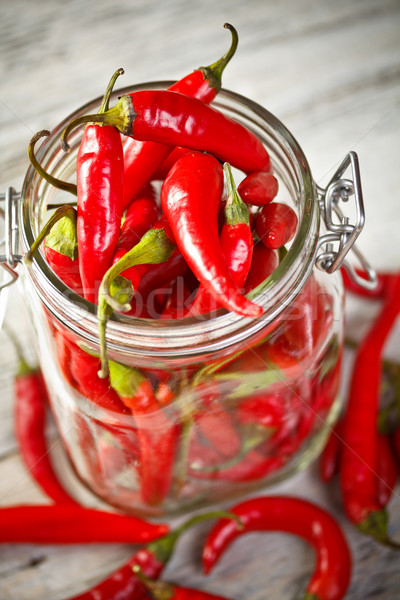 Glas jar Chilischoten alten Holztisch Hintergrund Stock foto © grafvision