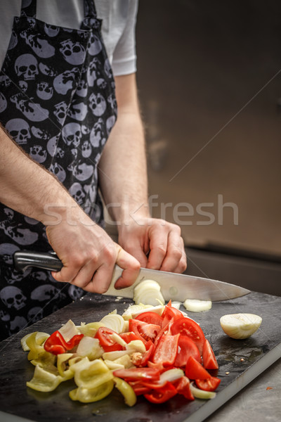 Stock photo: Chef is slicing vegetables