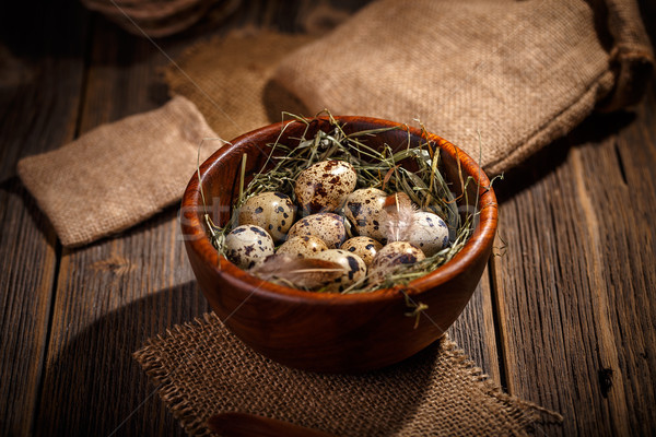 Quail eggs in wooden bowl Stock photo © grafvision
