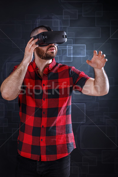 Young man using VR glasses Stock photo © grafvision