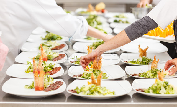 Cooks are garnishing appetizer dishes Stock photo © grafvision