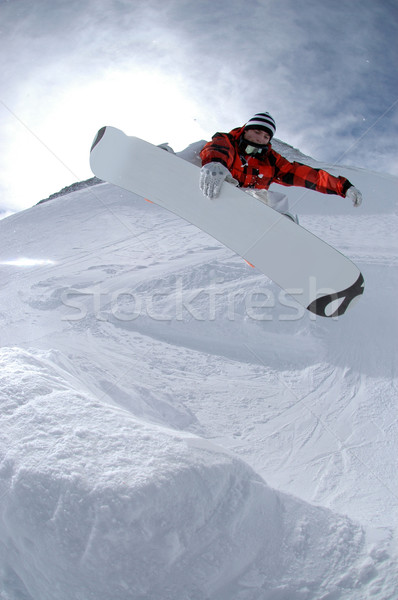 Jumping freestyle snowboarder sport montagna rosso Foto d'archivio © gravityimaging
