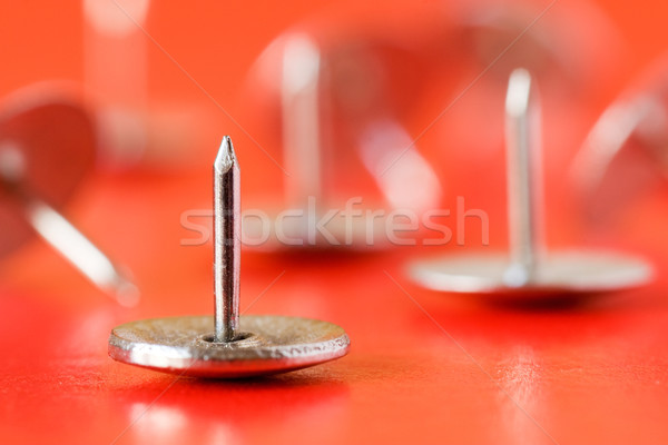 Stock photo: drawing pins on red background