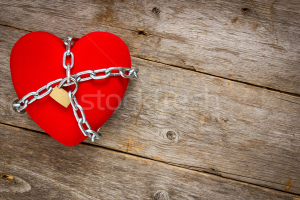 Heart with chains on wooden background Stock photo © Grazvydas