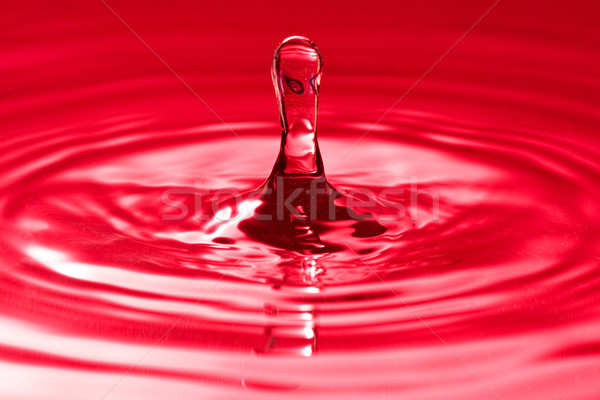droplet splash in a red water Stock photo © Grazvydas