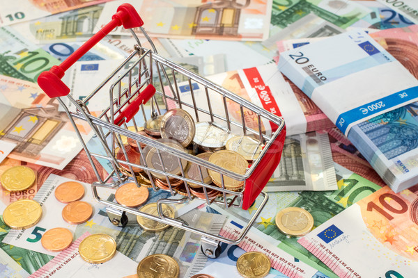 Shopping cart standing on euro banknotes  Stock photo © Grazvydas