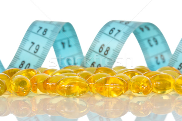 Fish oil capsules  and  measuring tape  Stock photo © Grazvydas