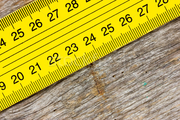 Yellow ruler on a wooden background Stock photo © Grazvydas