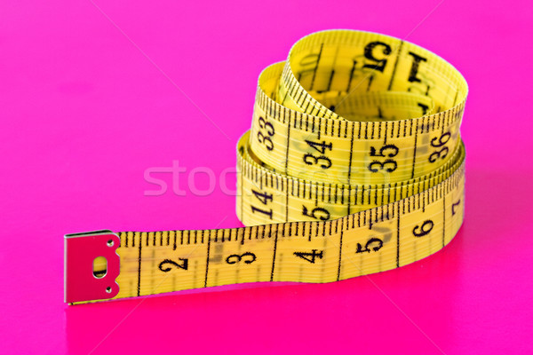 measuring tape on vivid pink background Stock photo © Grazvydas