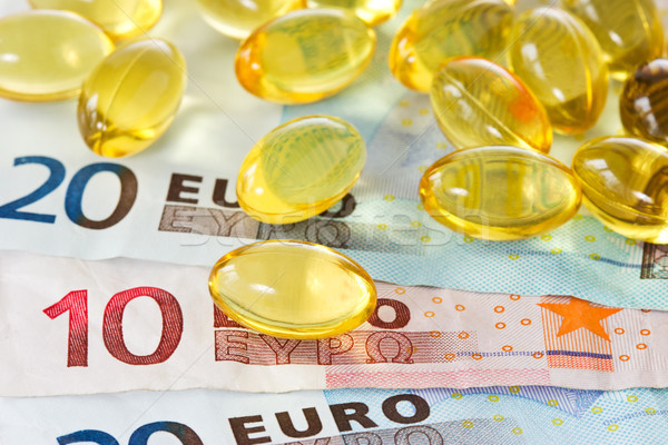 Médico despesas amarelo pílulas euro moeda Foto stock © Grazvydas