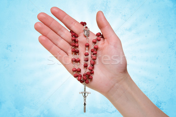 hand with rosary on blue abstract background Stock photo © Grazvydas