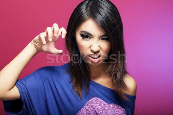 Stock photo: Negative Emotions. Expressive Asian Female Threatens
