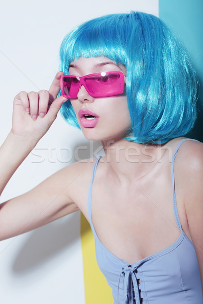 Individuality. Woman wears Blue Glossy Wig and Pink Glasses Stock photo © gromovataya