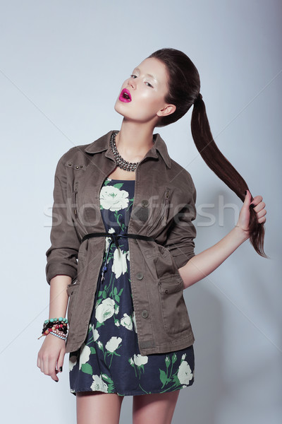 Trendy Fashion Model in Elegant Clothes holding her Tress Stock photo © gromovataya