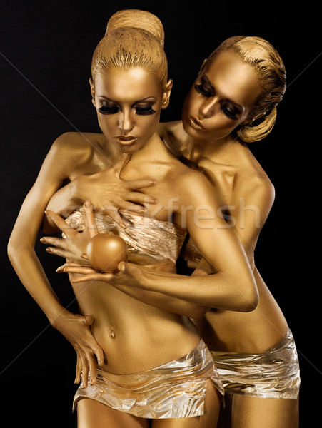 Glitter. Glaze. Seductive Women with Golden Bodies Hugging. Fantasy Stock photo © gromovataya