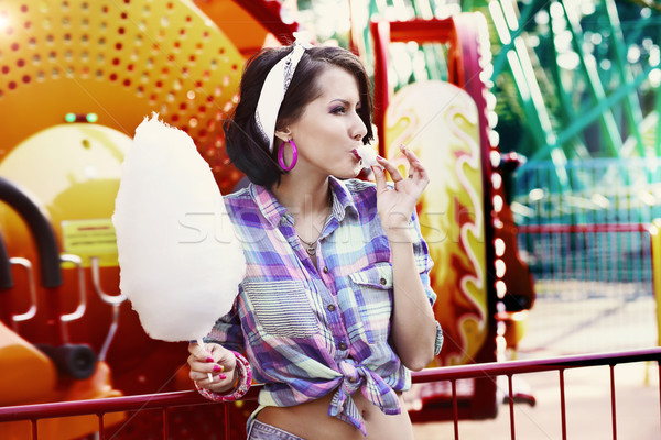 Young American Woman in Amusement Park Eating Cotton Candy Stock photo © gromovataya