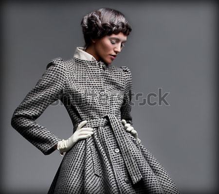 Fashion model lovely brunette in retro apparel posing in studio Stock photo © gromovataya