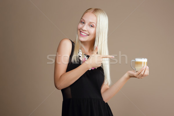 Happy Blond Woman Points Out to the Cup of Coffee Stock photo © gromovataya