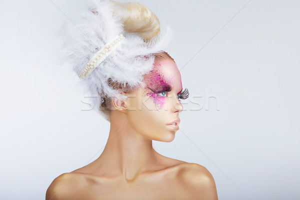 Creativity. Glamorous Fashion Model with Fancy Hair-do with Feathers Stock photo © gromovataya