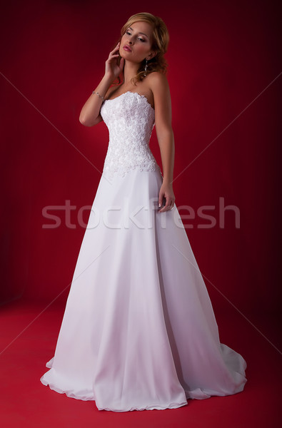 Fashionable blonde bride in long white wedding dress posing Stock photo © gromovataya