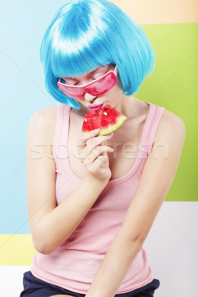 Trendy Woman in Blue Wig and ping Glasses Eating Watermelon Stock photo © gromovataya