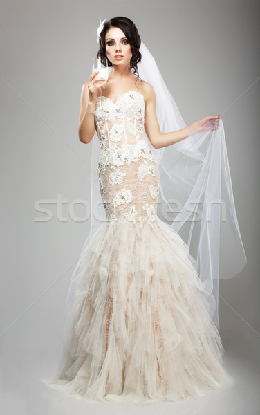 Fashionable Woman in White Dress holding Wineglass of Champagne Stock photo © gromovataya
