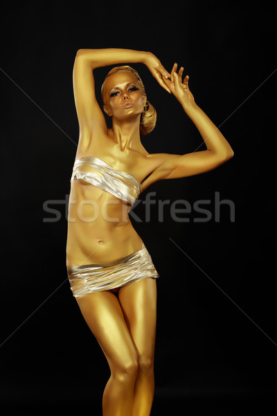 Bright Beauty. Beautiful Slim Woman with Golden Skin posing. Bodyart Stock photo © gromovataya