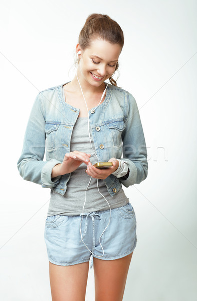 Young Woman in Jeans with Smartphone Stock photo © gromovataya