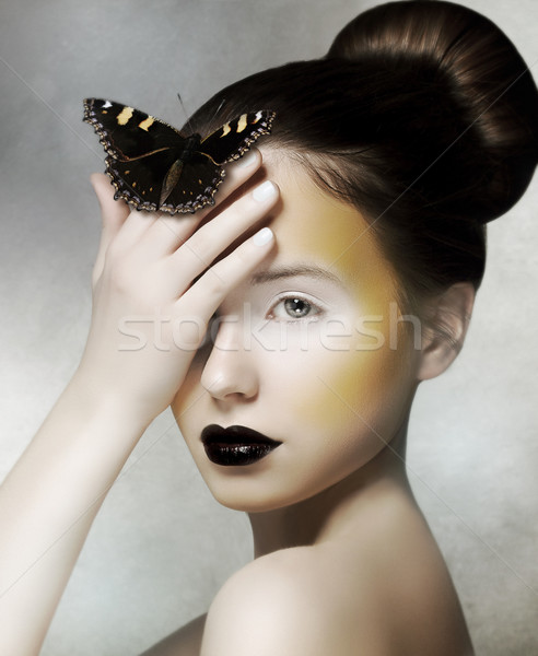 Romantic Woman holding Butterfly in her Hand. Fantasy Stock photo © gromovataya