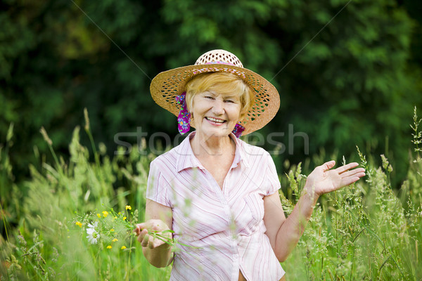 Joy. Friendly Happy Mature Woman in Straw Hut with Stretched Arms Stock photo © gromovataya