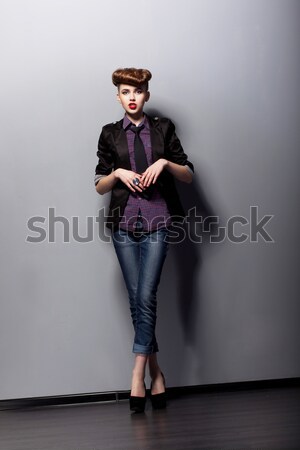 Casual fashion girl wearing blue jeans posing in studio Stock photo © gromovataya