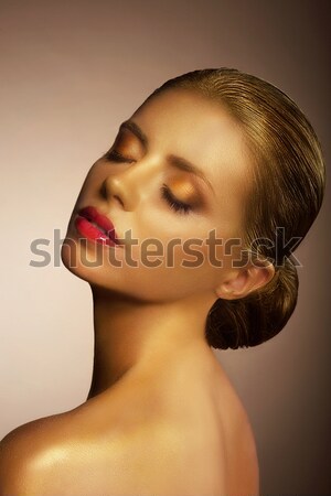 Artistry. Fanciful Bronzed Woman's Face. Futuristic Art Gold Makeup Stock photo © gromovataya