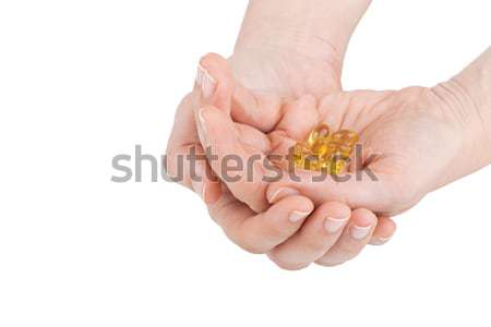 Kezek tart D-vitamin tabletták fehér kéz Stock fotó © gsermek