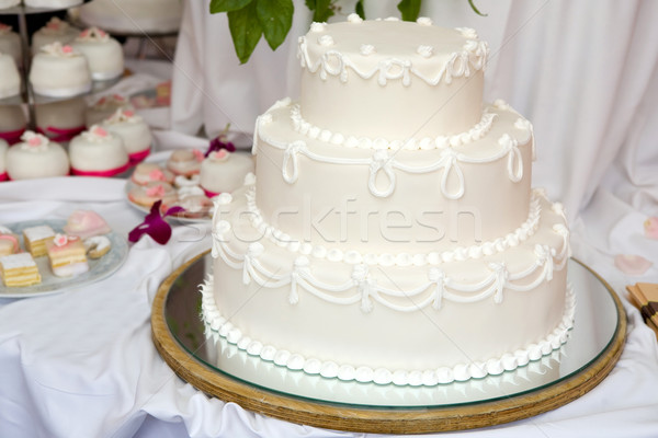 Stock photo: Three tiered wedding cake with white icing 