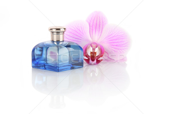 Parfüm şişe orkide çiçek yalıtılmış beyaz Stok fotoğraf © gsermek