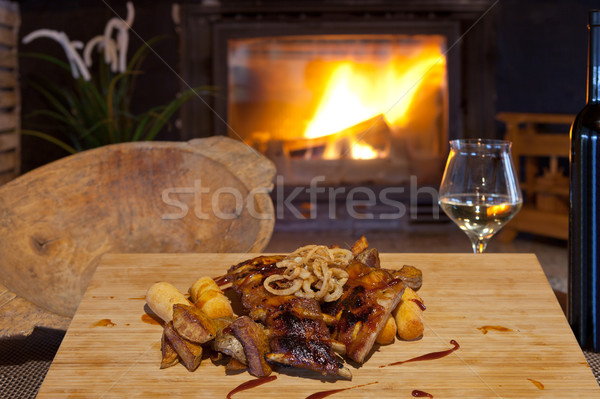 Grilled ribs topped with barbecue sauce and onion rings Stock photo © gsermek